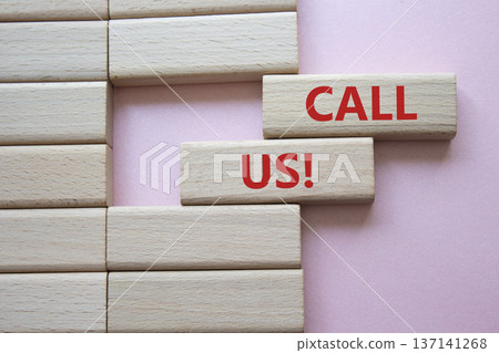 Call Us symbol. Wooden blocks with words Call Us. Beautiful pink background. Business and Call Us concept. Copy space. 137141268
