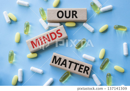 Our Minds Matter symbol. Concept words Our Minds Matter on wooden blocks. Beautiful blue background with pills. Healthcare and Our Minds Matter concept. Copy space. 137141309