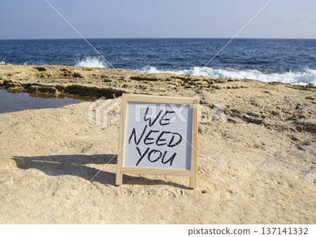 We need you symbol. Concept words We need you on white chalk blackboard blocks. Beautiful sea background. Business and We need you concept. Copy space. We need you symbol. Concept words We need you on white chalk blackboard blocks. Beautiful sea background. Business and We need you concept. Copy space. 137141332
