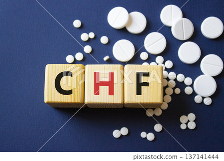 CHF symbol. Wooden cubes with words CHF Congestive Heart Failure. Beautiful deep blue background. Healthcare and Congestive Heart Failure concept. Copy space. 137141444