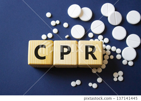 CPR symbol. Wooden cubes with words CPR Cardiopulmonary Resuscitation. Beautiful deep blue background. Healthcare and Cardiopulmonary Resuscitation concept. Copy space. CPR symbol. Wooden cubes with words CPR Cardiopulmonary Resuscitation. Beautiful deep blue background. Healthcare and Cardiopulmonary Resuscitation concept. Copy space. 137141445