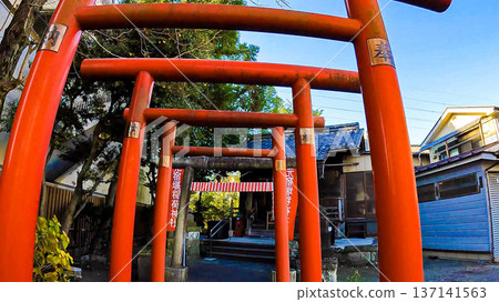 A row of red torii gates under the blue sky and Motoyadoseki Inari Shrine A row of red torii gates under the blue sky and Motoyadoseki Inari Shrine 137141563