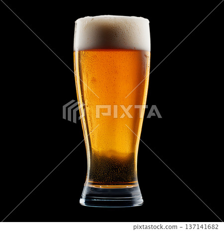 Foamy amber ale beer in a tall glass with creamy foam head, isolated on black background, concept of refreshment and taste Foamy amber ale beer in a tall glass with creamy foam head, isolated on black background, concept of refreshment and taste 137141682