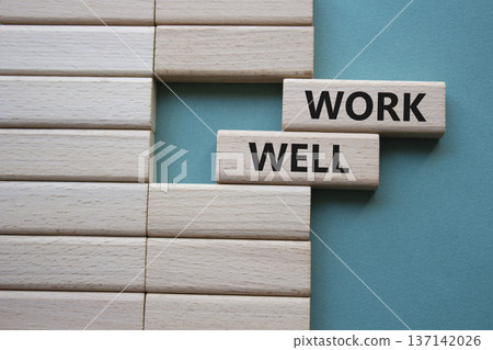 Work Well symbol. Concept word Work Well on wooden blocks. Beautiful grey green background. Business and Work Well concept. Copy space Work Well symbol. Concept word Work Well on wooden blocks. Beautiful grey green background. Business and Work Well concept. Copy space 137142026