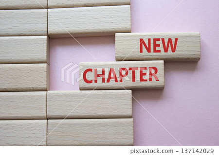 New Chapter symbol. Concept word New Chapter on wooden blocks. Beautiful pink background. Business and New Chapter concept. Copy space 137142029