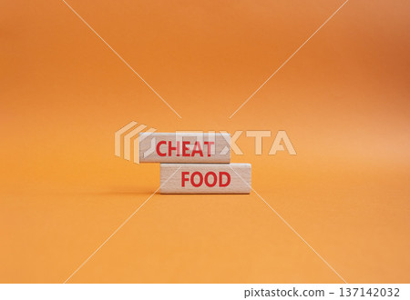 Cheat Food symbol. Wooden blocks with words Cheat Food. Beautiful orange background. Health and Cheat Food concept. Copy space. Cheat Food symbol. Wooden blocks with words Cheat Food. Beautiful orange background. Health and Cheat Food concept. Copy space. 137142032