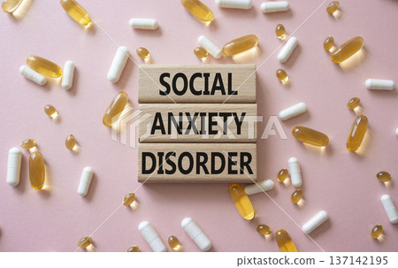 Social Anxiety Disorder symbol. Concept words Social Anxiety Disorder on wooden blocks. Beautiful pink background with pills. Healthcare and Social Anxiety Disorder concept. Copy space. Social Anxiety Disorder symbol. Concept words Social Anxiety Disorder on wooden blocks. Beautiful pink background with pills. Healthcare and Social Anxiety Disorder concept. Copy space. 137142195