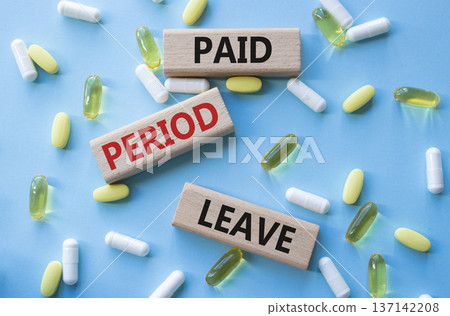 Paid Period Leave symbol. Concept words Paid Period Leave on wooden blocks. Beautiful blue background with pills. Healthcare and Paid Period Leave concept. Copy space. Paid Period Leave symbol. Concept words Paid Period Leave on wooden blocks. Beautiful blue background with pills. Healthcare and Paid Period Leave concept. Copy space. 137142208