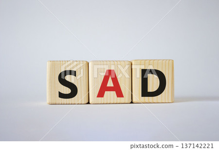 Sad symbol. Wooden cubes with words Sad. Beautiful white background. Business and Sad concept. Copy space. Sad symbol. Wooden cubes with words Sad. Beautiful white background. Business and Sad concept. Copy space. 137142221