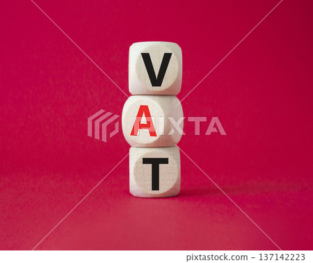 VAT - Value Added Tax symbol. Wooden cubes with word VAT. Beautiful red background. Business and Value Added Tax concept. Copy space. VAT - Value Added Tax symbol. Wooden cubes with word VAT. Beautiful red background. Business and Value Added Tax concept. Copy space. 137142223