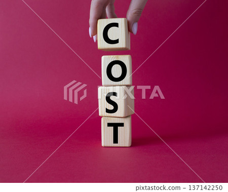 Cost symbol. Concept word Cost on wooden cubes. Beautiful red background. Businessman hand. Business and Cost concept. Copy space. Cost symbol. Concept word Cost on wooden cubes. Beautiful red background. Businessman hand. Business and Cost concept. Copy space. 137142250