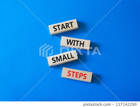 Steps symbol. Concept words Start with Small Steps on wooden blocks. Beautiful bright blue background. Business and Start with Small Steps concept. Copy space. 137142290
