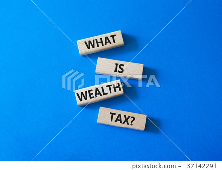 Tax symbol. Concept words What is Wealth Tax on wooden blocks. Beautiful bright blue background. Business and What is Wealth Tax concept. Copy space. Tax symbol. Concept words What is Wealth Tax on wooden blocks. Beautiful bright blue background. Business and What is Wealth Tax concept. Copy space. 137142291