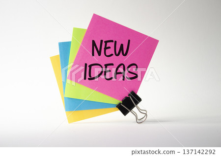 New ideas symbol. Pink sticky note with concept words New Ideas. Beautiful white background. Business and New ideas concept. Copy space New ideas symbol. Pink sticky note with concept words New Ideas. Beautiful white background. Business and New ideas concept. Copy space 137142292