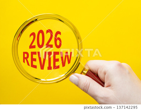 2026 Review symbol. Magnifying Glass with words 2026 Review. Beautiful yellow background. Businessman hand. Business and 2026 Review concept. Copy space. 137142295