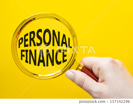 Personal Finance symbol. Magnifying Glass with words Personal Finance. Businessman hand. Beautiful yellow background. Business and Personal Finance concept. Copy space. 137142296