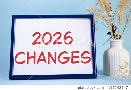 2026 Changes symbol. Concept words 2026 Changes on beautiful wooden picture frame. Beautiful light blue background with flower vase. Business and 2026 Changes concept. Copy space. 2026 Changes symbol. Concept words 2026 Changes on beautiful wooden picture frame. Beautiful light blue background with flower vase. Business and 2026 Changes concept. Copy space. 137142347