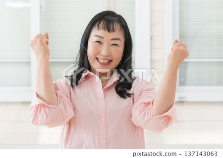 A smiling woman cheering up A smiling woman cheering up 137143063