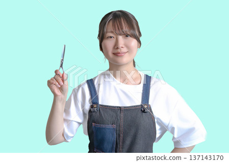 Smiling woman with scissors 137143170