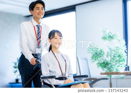 坐在輪椅上在辦公室工作的婦女 137143243