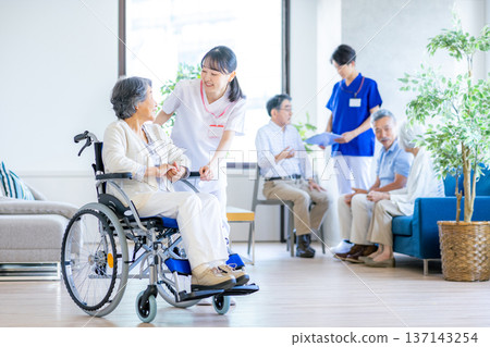 Senior woman and carer in wheelchair Senior woman and carer in wheelchair 137143254