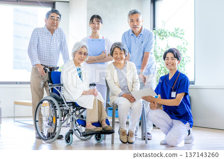 Elderly people in wheelchairs and caregivers 137143260