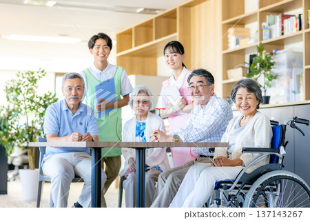 Young helpers and seniors cuddling at a nursing home 137143267