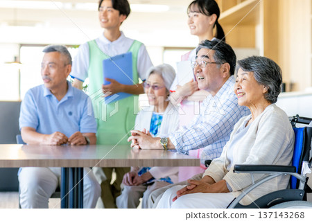 Young helpers and seniors cuddling at a nursing home 137143268