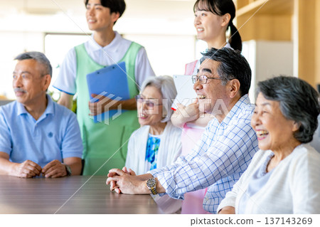 Young helpers and seniors cuddling at a nursing home 137143269