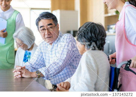 Young helpers and seniors cuddling at a nursing home 137143272