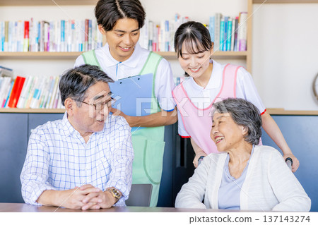 Young helpers and seniors cuddling at a nursing home 137143274