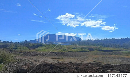 Scenic Industrial Construction Site with Mountain Backdrop and Blue Sky Scenic Industrial Construction Site with Mountain Backdrop and Blue Sky 137143377