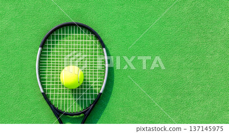 Tennis Racket and Ball on Green Court Background with Copy Space 137145975