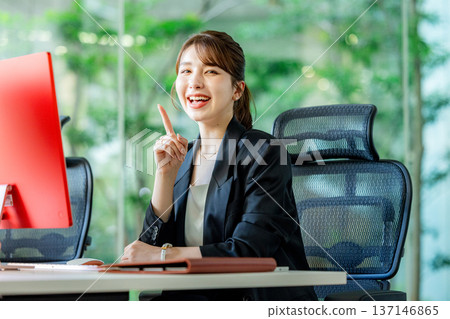Foreign woman working on a computer in the office 137146865