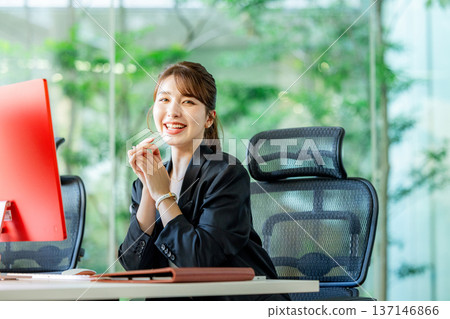 Foreign woman working on a computer in the office Foreign woman working on a computer in the office 137146866