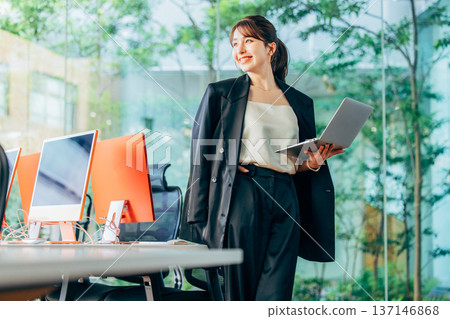 Foreign woman working on a computer in the office Foreign woman working on a computer in the office 137146868