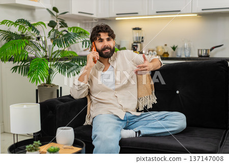 Indian man talking smartphone with employer relaxed smile friendly phone call listening happy mood 137147008