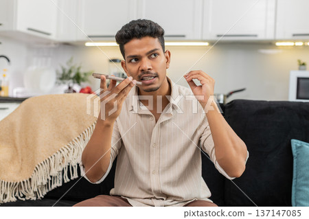Indian man records voice message on smartphone talks in audio chat gestures to highlight key points Indian man records voice message on smartphone talks in audio chat gestures to highlight key points 137147085