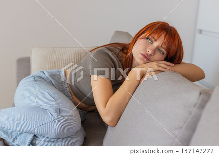 Young woman with laptop looks exhausted bad mood after tough news silent stare long pause heavy sigh 137147272