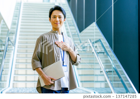 Middle-aged man in the office corridor Middle-aged man in the office corridor 137147285