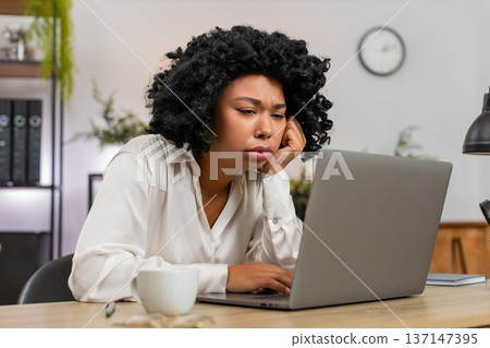 African American businesswoman disappointed sees laptop screen after game loss news client rejection 137147395
