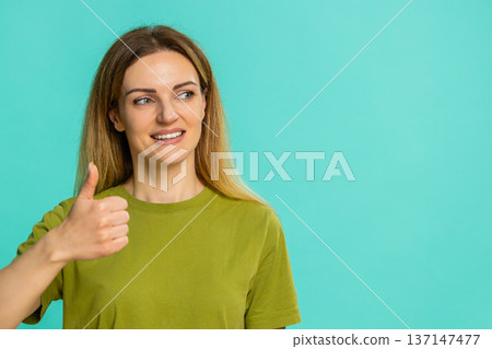 Adult woman showing thumbs up and smiling expressing support agreement approval or positive response Adult woman showing thumbs up and smiling expressing support agreement approval or positive response 137147477
