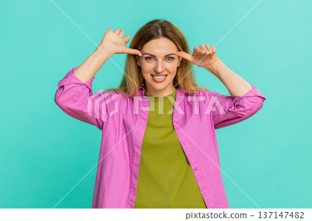 Woman sticking out tongue teasing with playful expression showing fun joke or mild mocking gesture 137147482