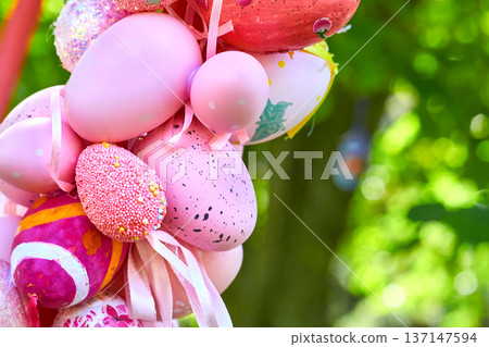 Pink spring bouquet of colorful painted Easter eggs on green tree Pink spring bouquet of colorful painted Easter eggs on green tree 137147594