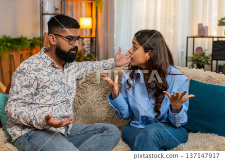 Indian family couple man woman having emotional discussion at home, minor argument with gestures Indian family couple man woman having emotional discussion at home, minor argument with gestures 137147917
