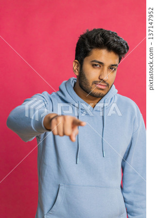 Happy Indian smiling man pointing finger to camera making winner choice, showing direction, select 137147952