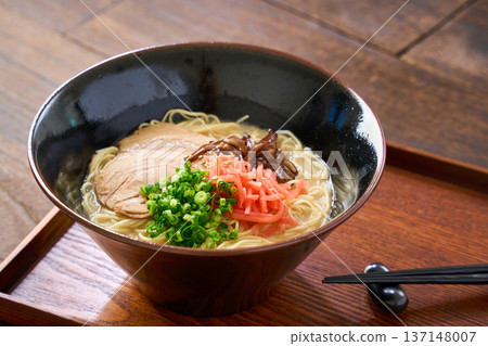 Pork bone ramen topped with roasted pork and pickled ginger 137148007