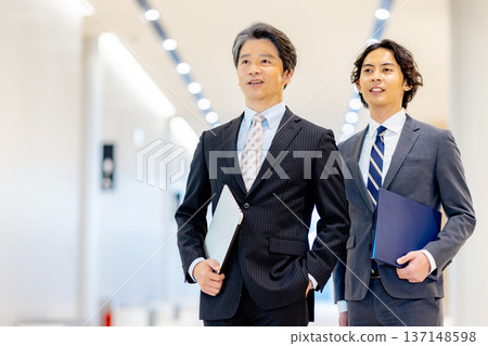 Businessman with laptop in office Businessman with laptop in office 137148598