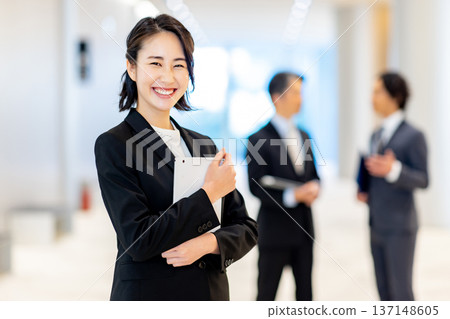 Smiling businesswoman holding a tablet Smiling businesswoman holding a tablet 137148605