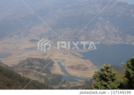 A view of the mountains, houses, lakes, rivers and fields in Pokhara, Nepal A view of the mountains, houses, lakes, rivers and fields in Pokhara, Nepal 137149199